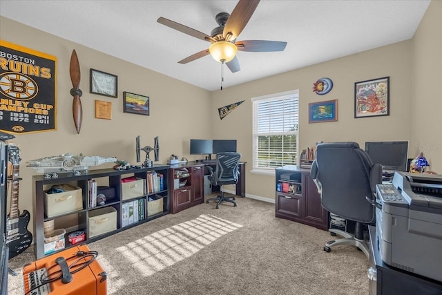 home office featuring ceiling fan and light carpet