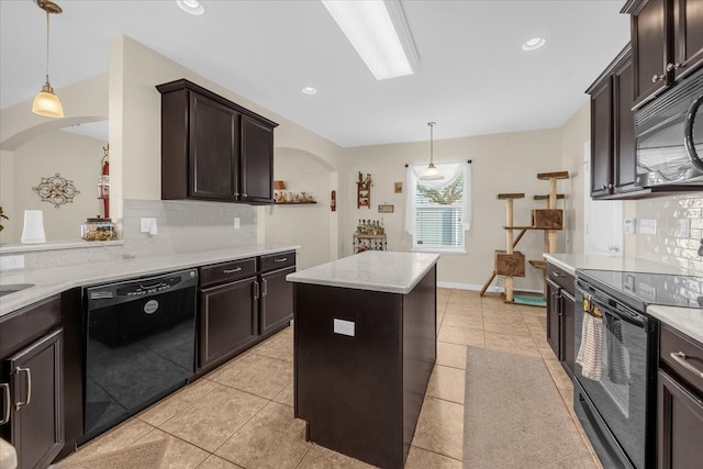 kitchen featuring a kitchen island, decorative light fixtures, backsplash, light tile patterned floors, and black appliances