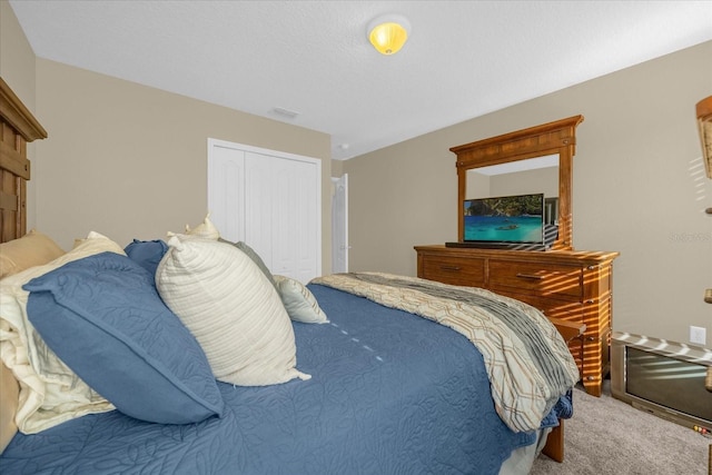 bedroom with a closet and carpet flooring