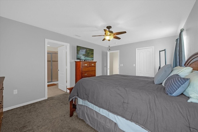 carpeted bedroom featuring a closet, ceiling fan, and ensuite bath