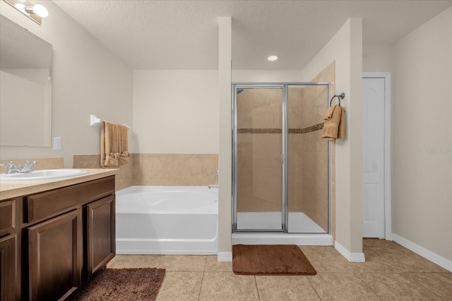 bathroom featuring tile patterned floors, plus walk in shower, and a textured ceiling