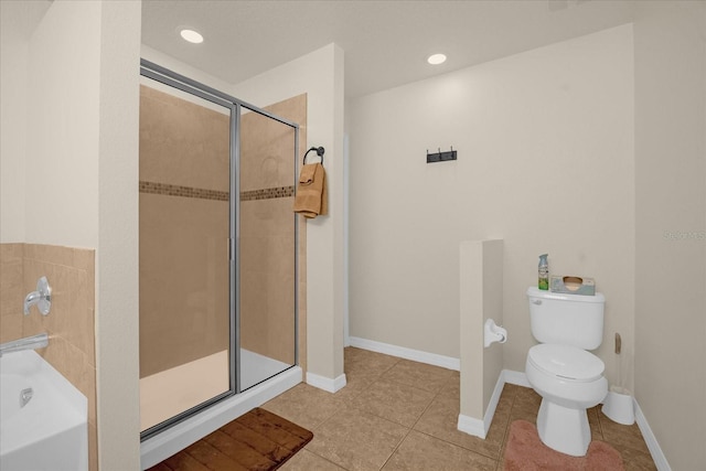 bathroom with tile patterned flooring, shower with separate bathtub, and toilet