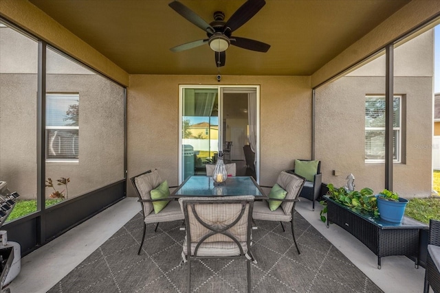 sunroom / solarium with a wealth of natural light and ceiling fan