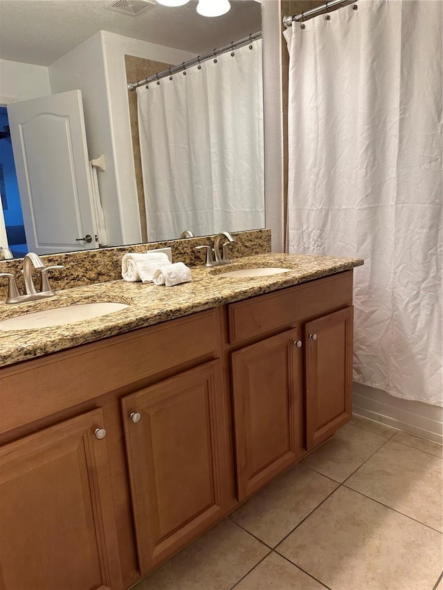 bathroom with vanity and tile patterned floors