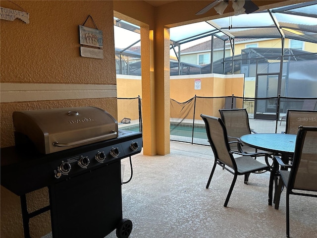 view of patio with a grill and a lanai