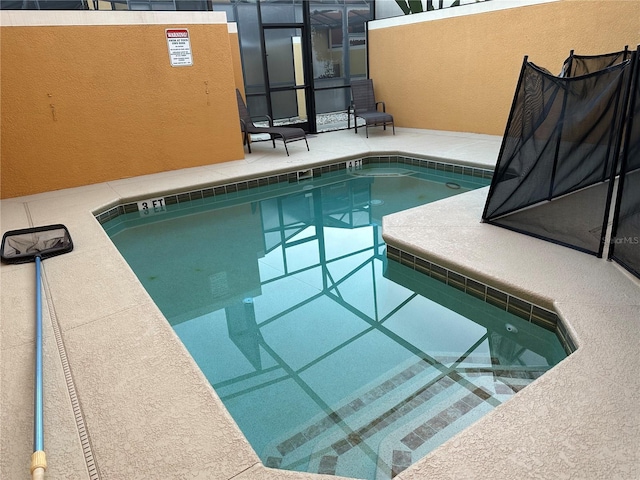 view of swimming pool with a lanai