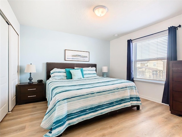 bedroom featuring light hardwood / wood-style floors and a closet