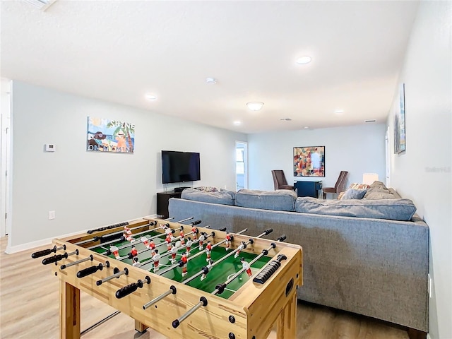 recreation room with wood-type flooring