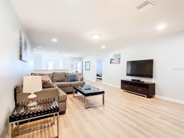 living room with light hardwood / wood-style flooring