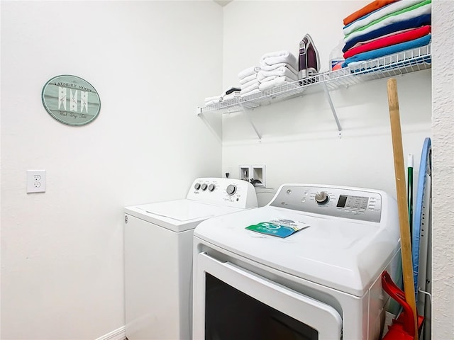 clothes washing area featuring independent washer and dryer