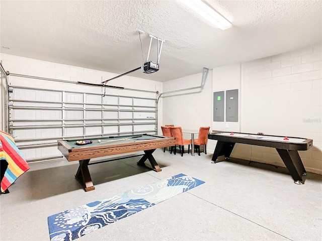 recreation room with electric panel and a textured ceiling