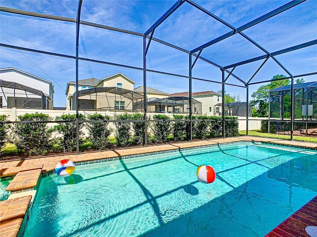 view of swimming pool with a lanai