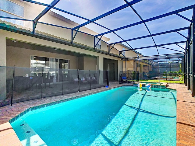 view of swimming pool featuring an in ground hot tub, a patio, and glass enclosure