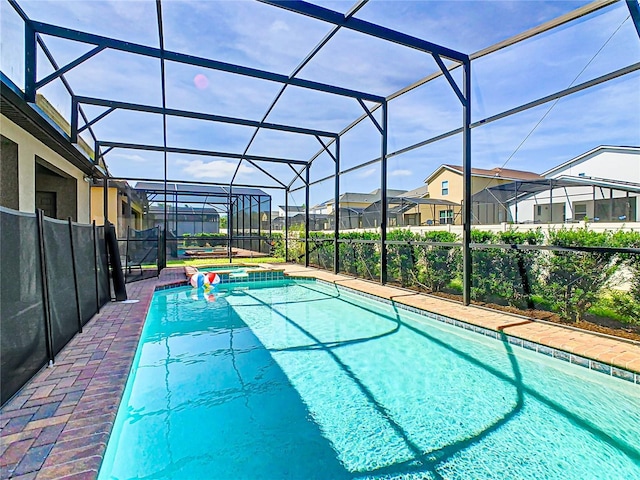 view of pool with an in ground hot tub and a lanai