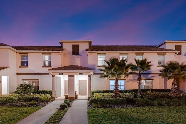 mediterranean / spanish-style house featuring a lawn