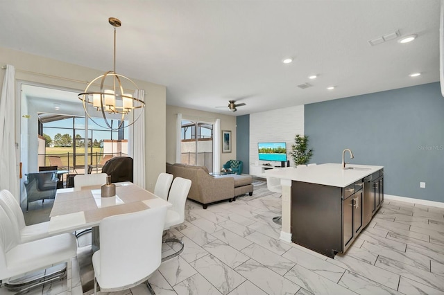 dining space featuring an inviting chandelier and sink