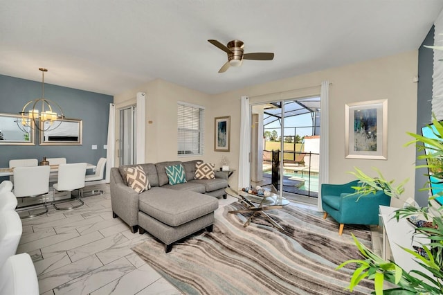 living room with ceiling fan with notable chandelier