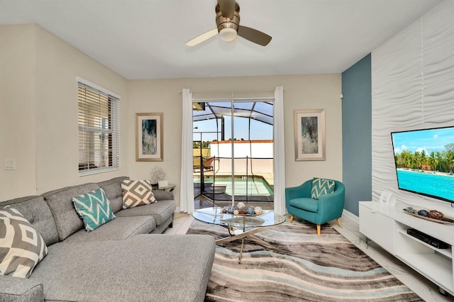 living room featuring ceiling fan and a wealth of natural light