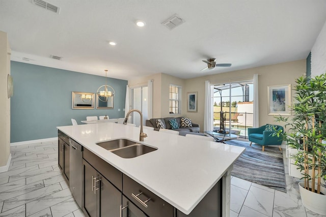 kitchen with sink, dark brown cabinets, hanging light fixtures, a center island with sink, and dishwasher