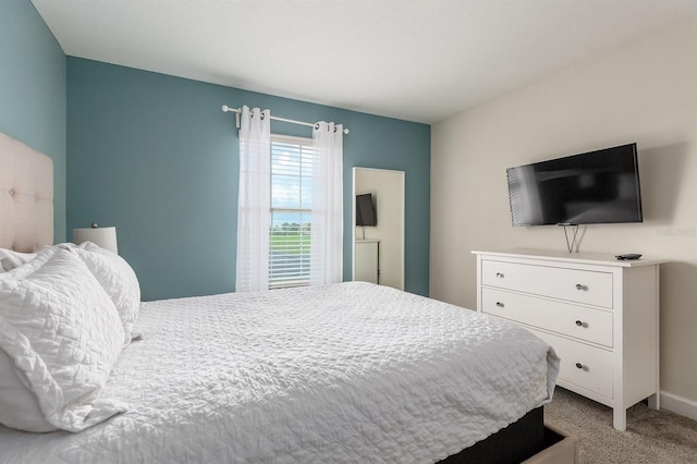 bedroom featuring light carpet