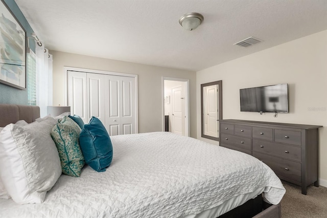 carpeted bedroom with a closet