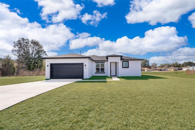 view of front of home featuring a garage and a front lawn