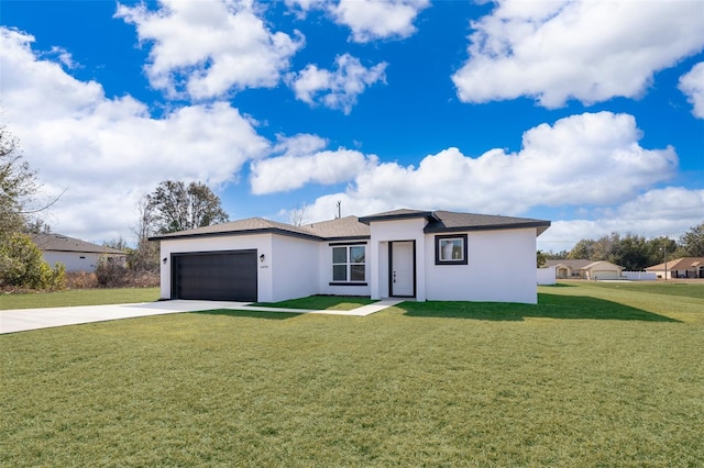 view of front of property with a garage and a front lawn