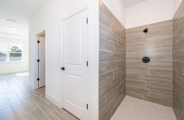 bathroom with a tile shower