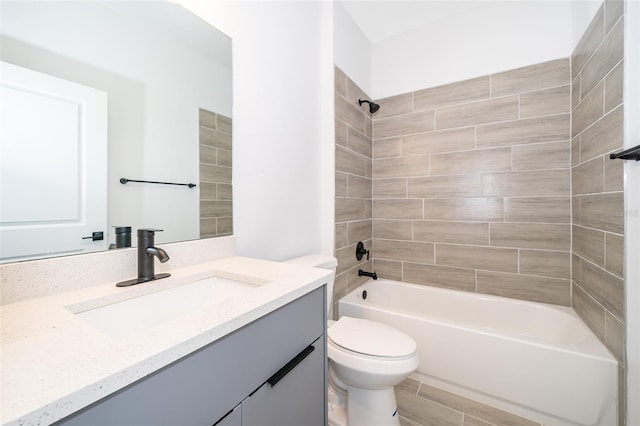 full bathroom featuring vanity, toilet, and tiled shower / bath