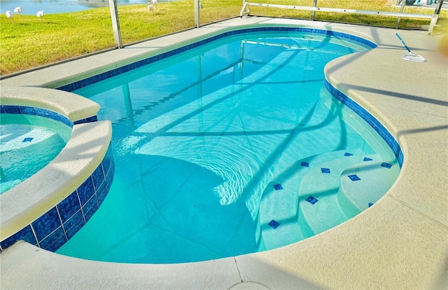 view of swimming pool featuring a lanai