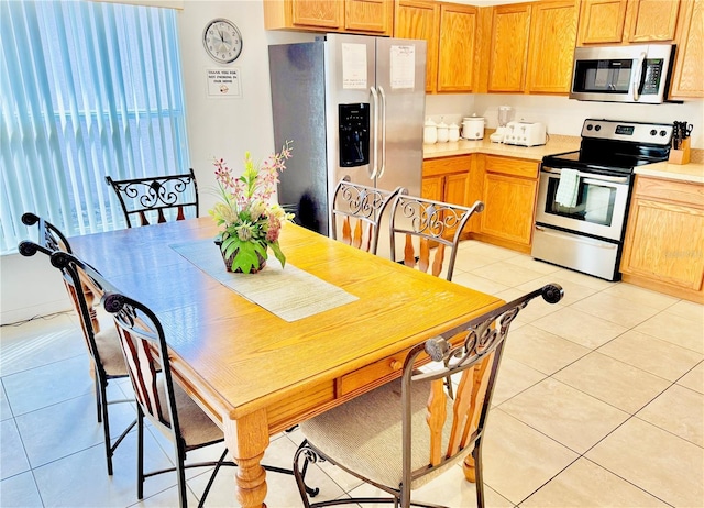 kitchen with light tile patterned floors and appliances with stainless steel finishes