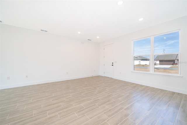 empty room with light hardwood / wood-style flooring