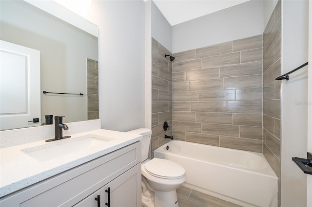 full bathroom featuring vanity, tiled shower / bath combo, toilet, and hardwood / wood-style flooring