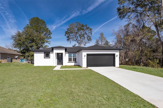 view of front of home with a garage and a front lawn