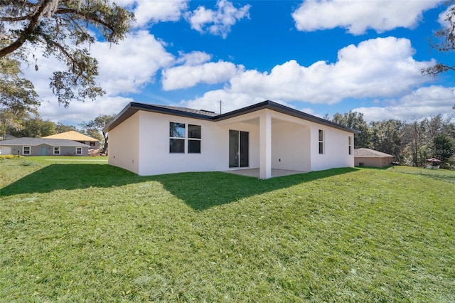 back of property featuring a yard and a patio area