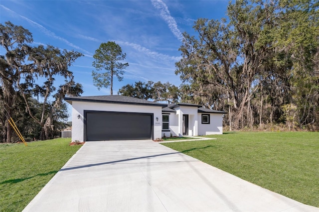 view of front of property with a garage and a front yard