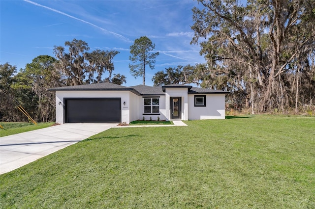 view of front of home with a garage and a front lawn