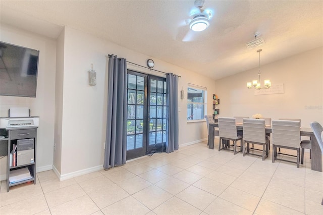 tiled dining area featuring french doors, lofted ceiling, ceiling fan with notable chandelier, and a textured ceiling