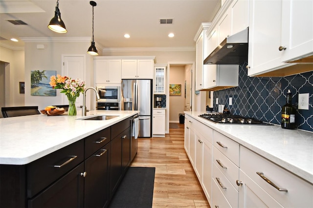 kitchen with stainless steel refrigerator with ice dispenser, white cabinets, sink, and gas stovetop