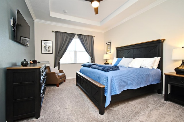 carpeted bedroom featuring crown molding, ceiling fan, and a tray ceiling