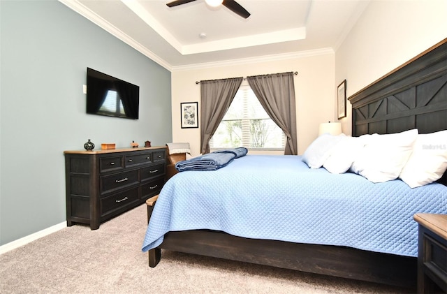 bedroom featuring a raised ceiling, crown molding, light carpet, and ceiling fan