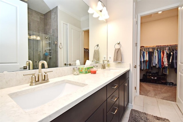 bathroom with vanity, tile patterned floors, crown molding, and walk in shower