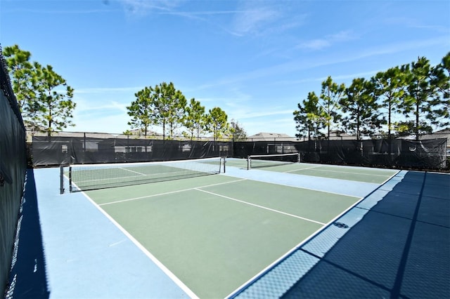 view of tennis court with basketball hoop