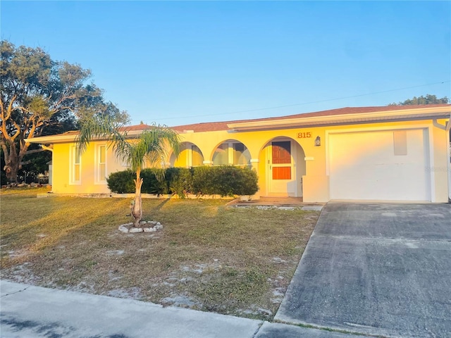 ranch-style house with a garage and a front yard