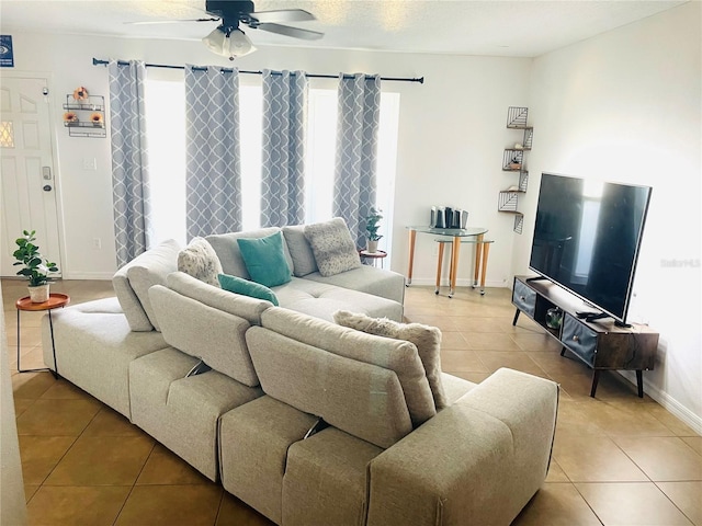 tiled living room featuring a textured ceiling and ceiling fan