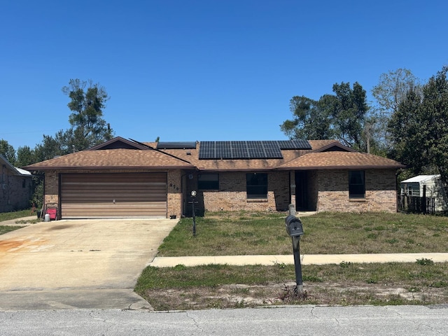 974 Feather Dr, Deltona, FL 32725 - single story home featuring an attached garage, solar panels, brick siding, driveway, and a shingled roof