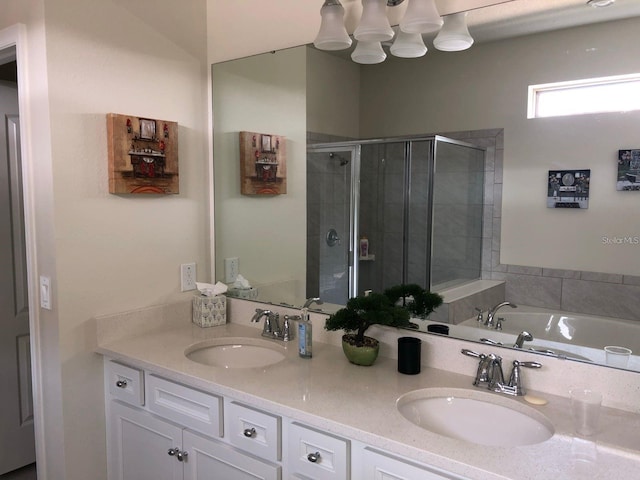 bathroom featuring shower with separate bathtub and vanity