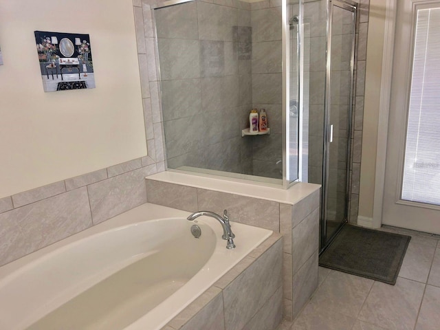 bathroom with tile patterned floors and separate shower and tub