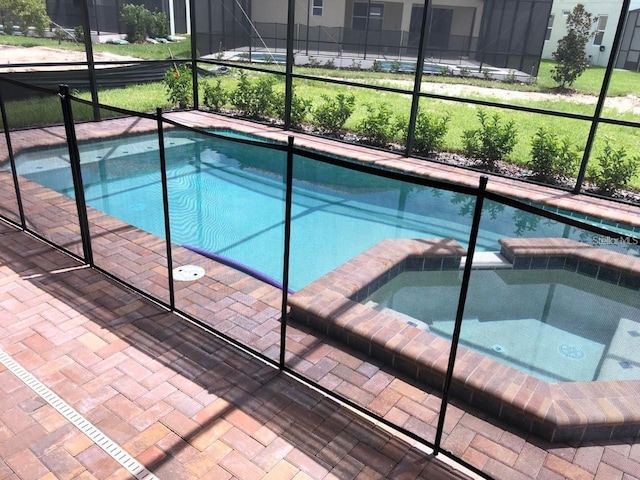 view of pool with an in ground hot tub