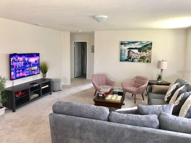 living room featuring light colored carpet and a textured ceiling